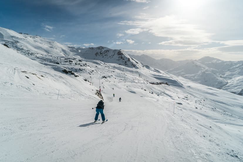 Skier on slope in Les Menuires ski resort in the three valleys