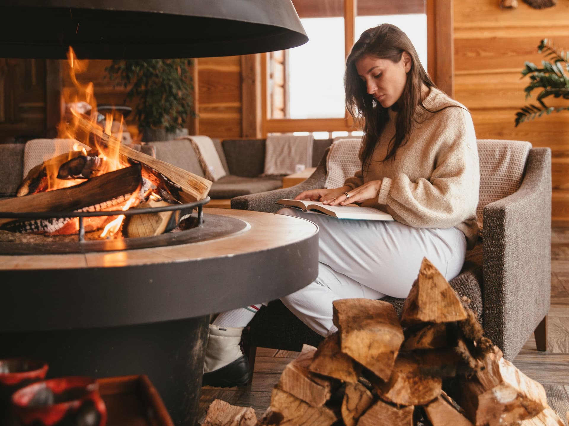 woman-reading-book-chalet-fireplace-cosy