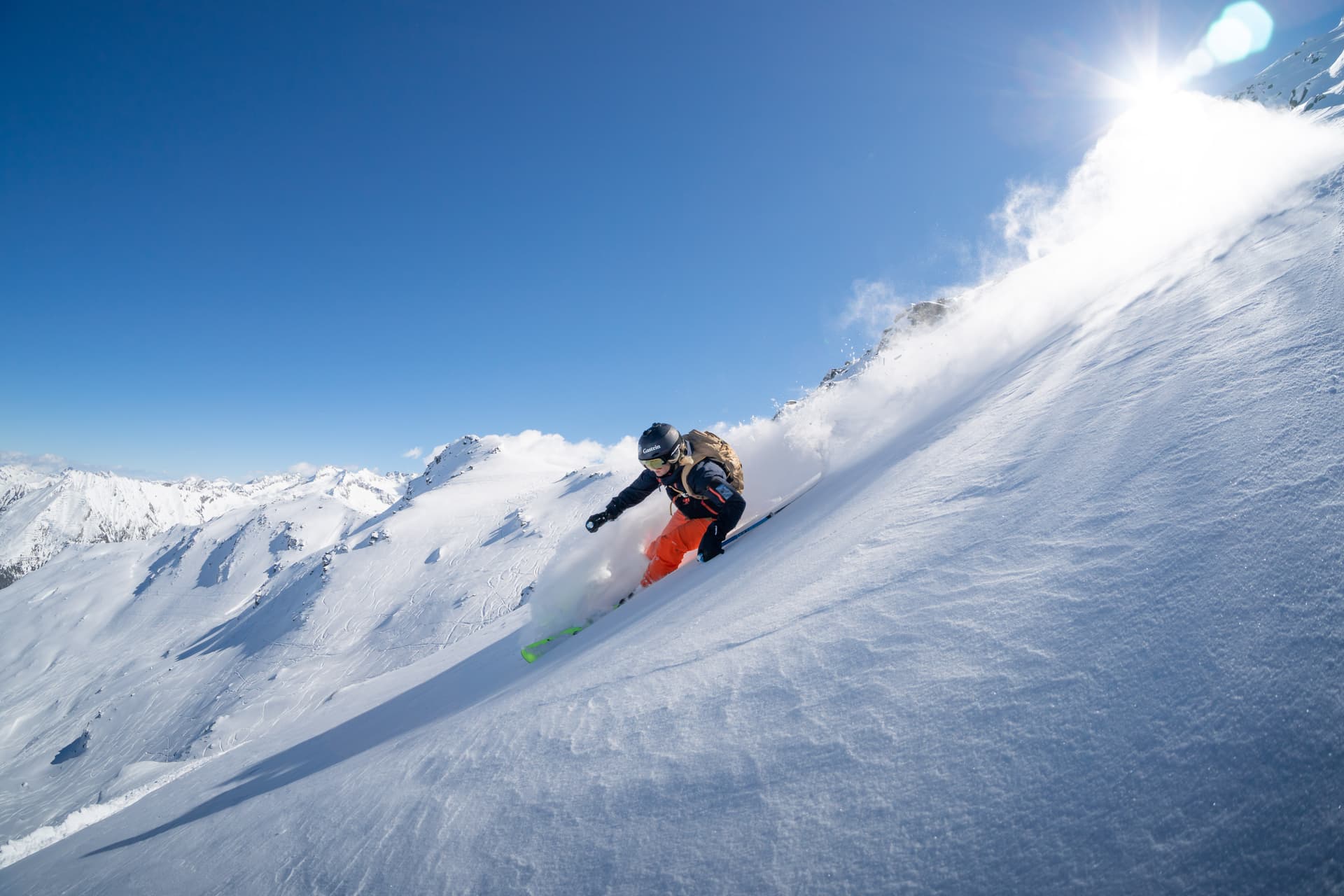 Skiier carving a turn off piste at Bad Gastein ski resort