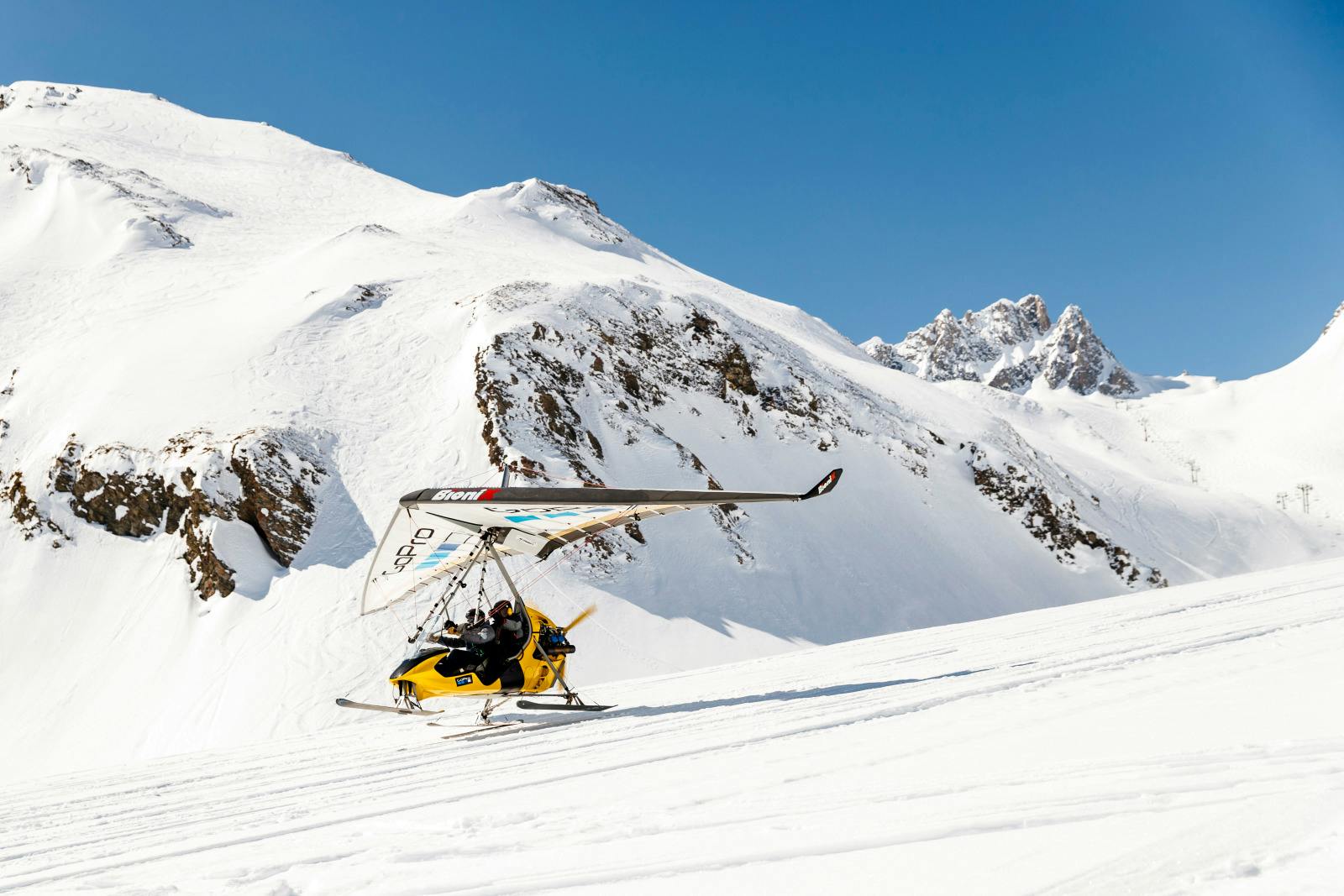 Skiers lifting off on glider at Tignes ski resort
