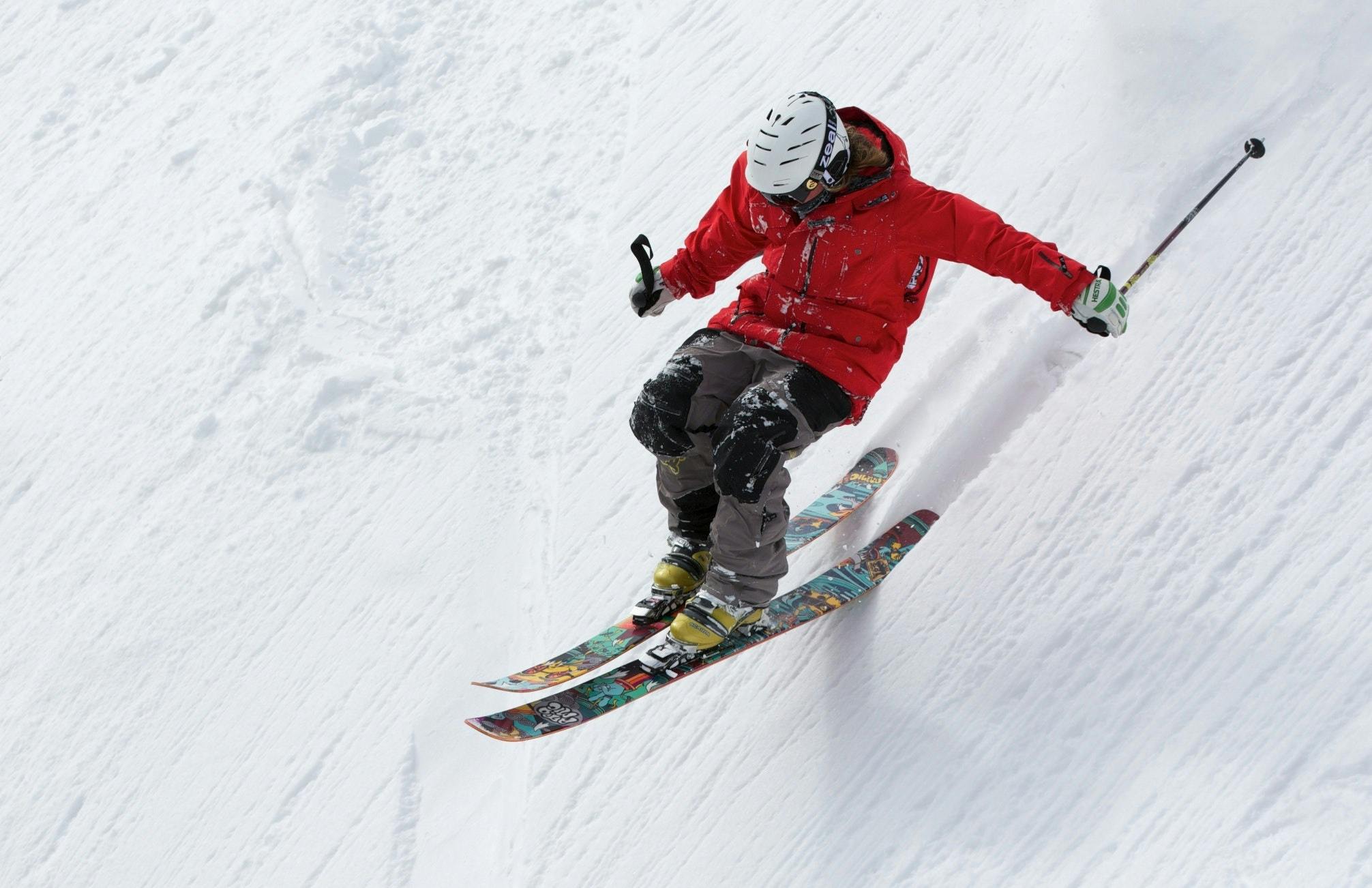 Skier skiing fast down steep slope