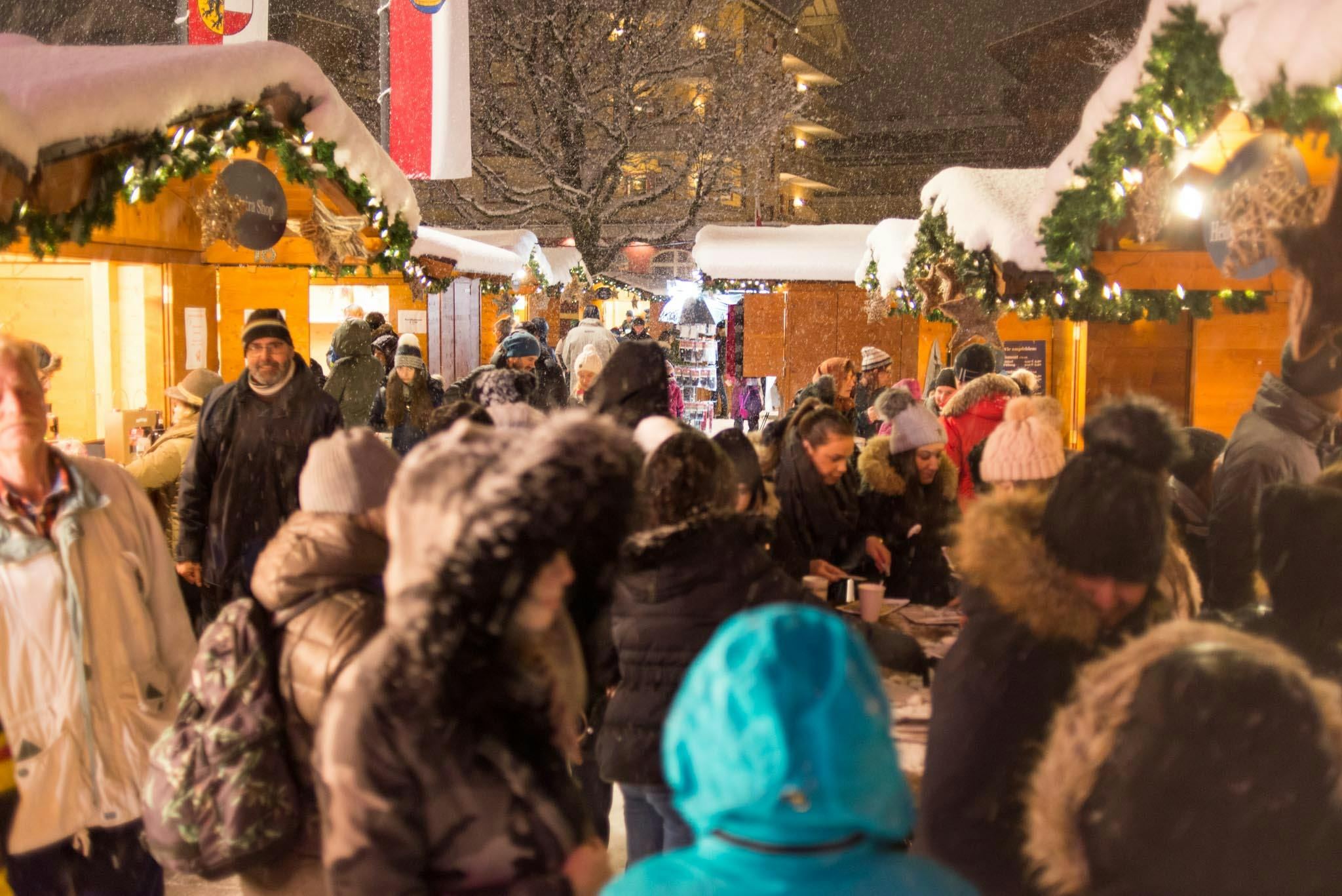 Families enjoying Austrian Christmas markets at night