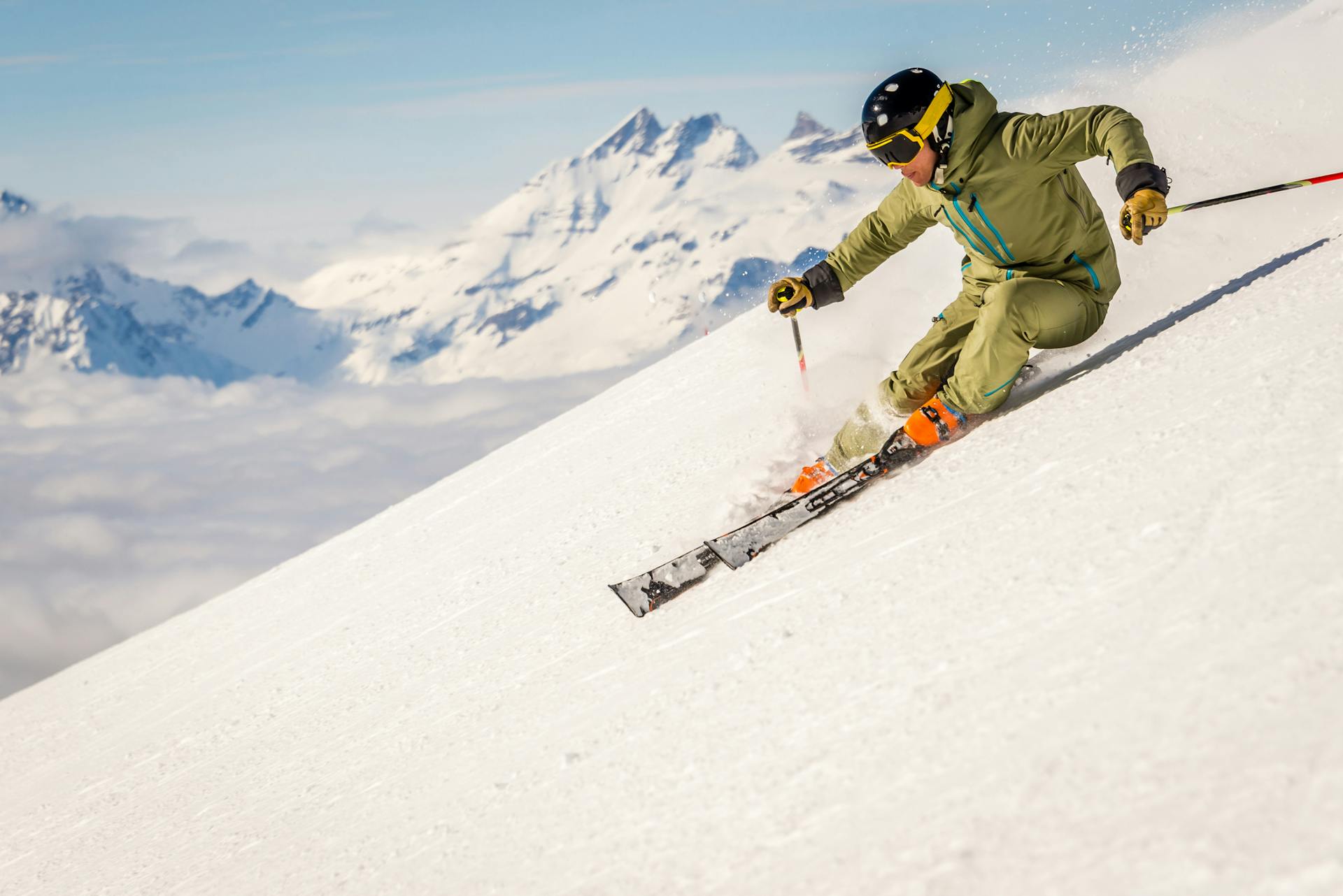 Skier speeds down steep mountain