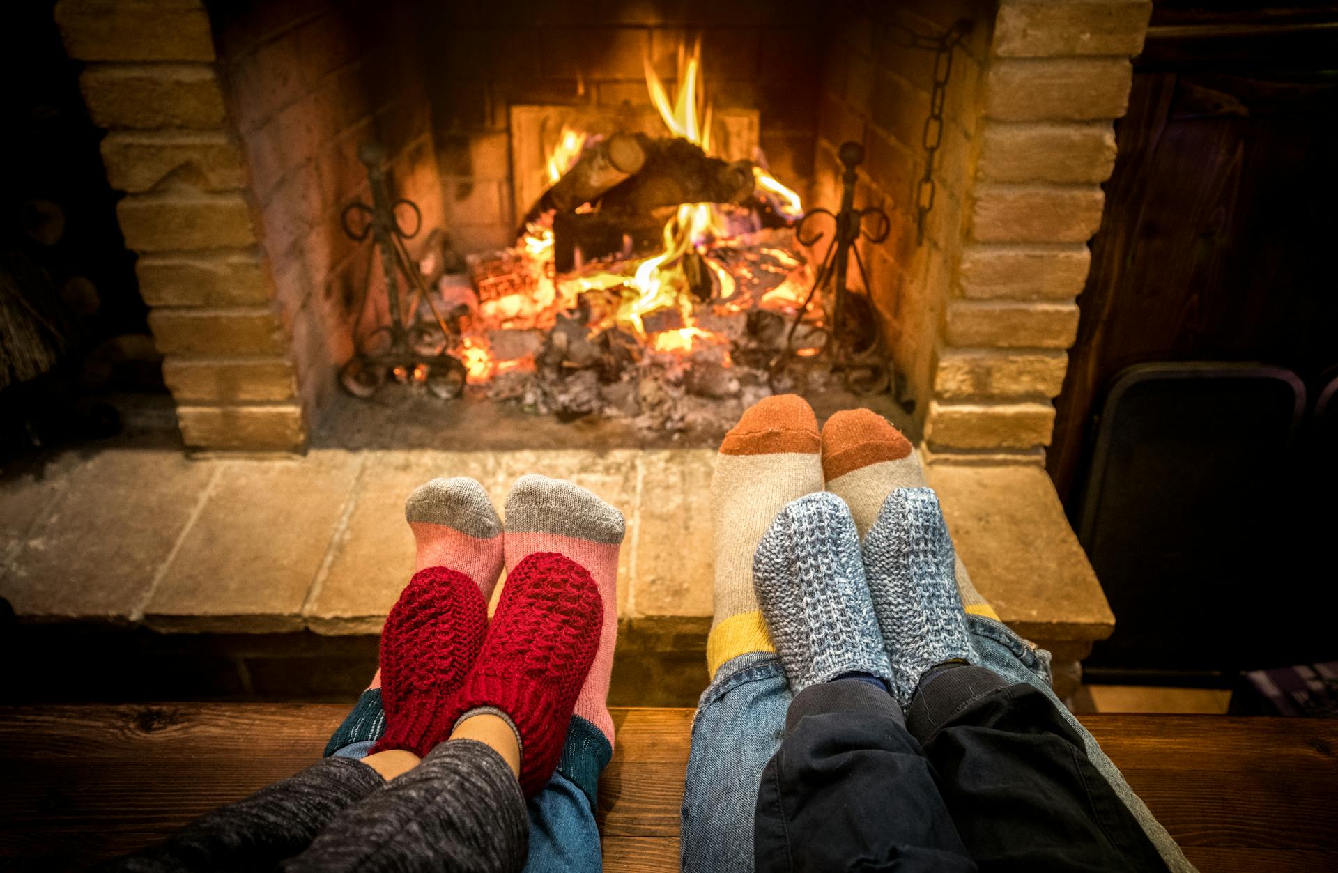 Family relaxing in front of fireplace at ski resort