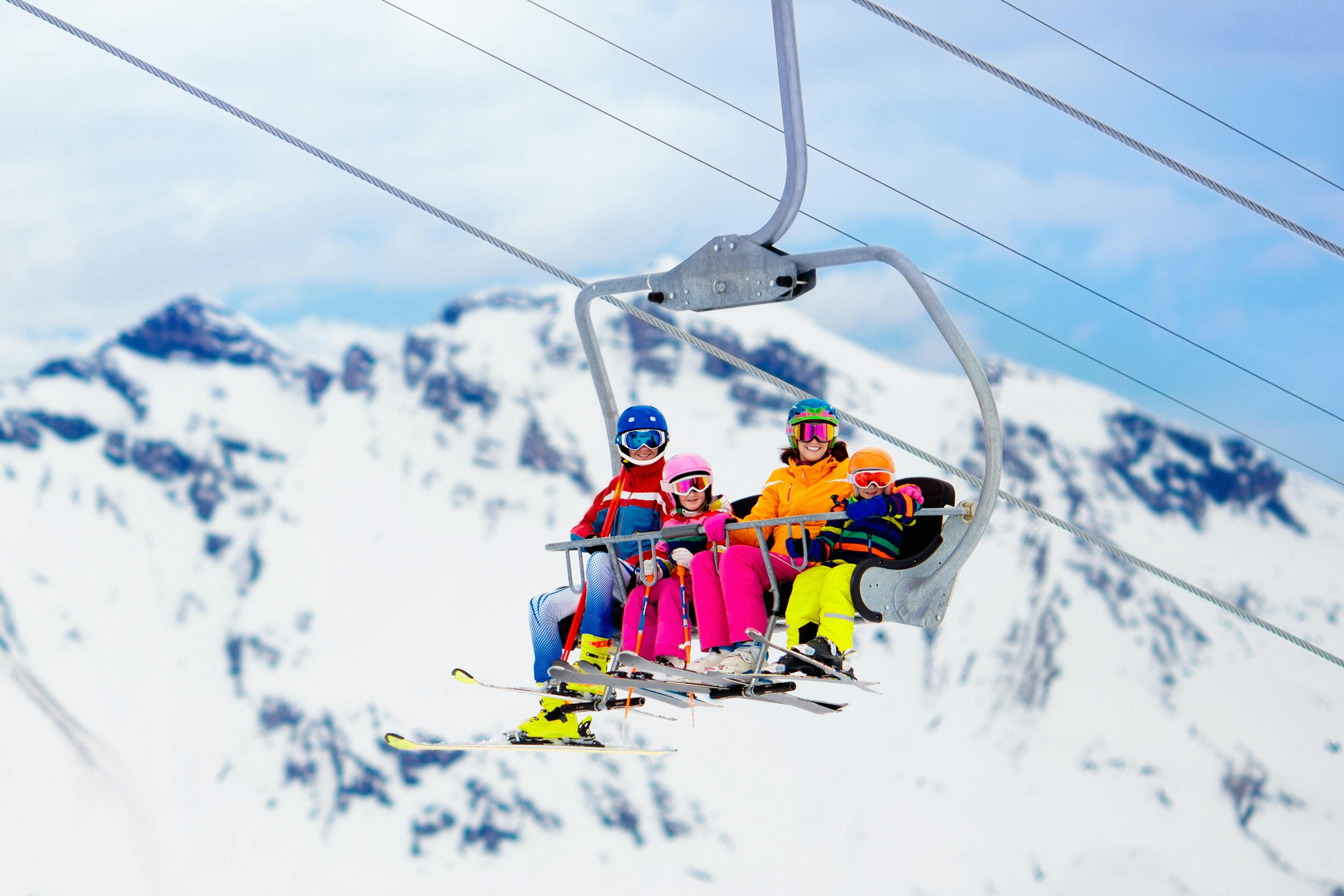 Family taking chairlift to top of mountain