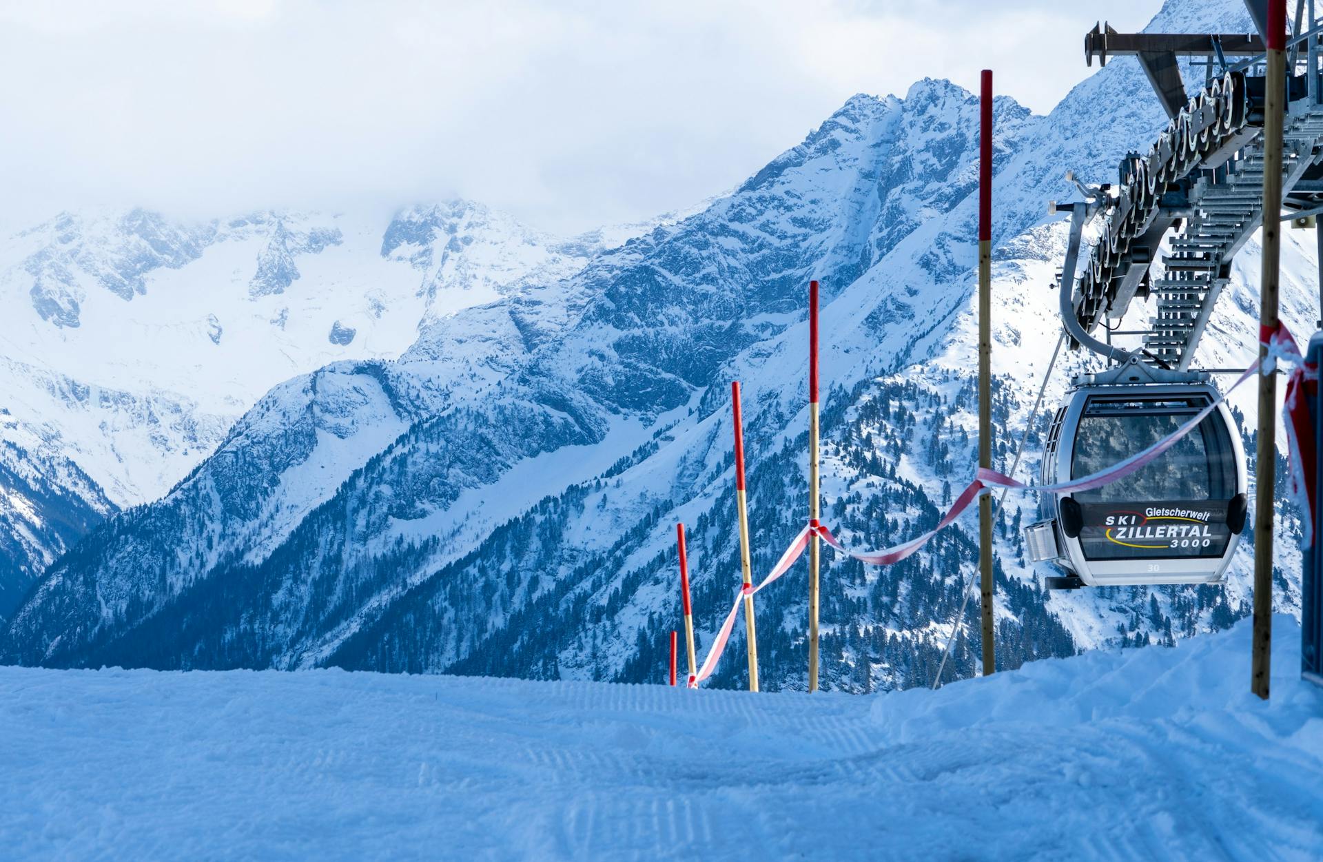 Gondola taking skiers to top of snowy mountain ski slope in Mayrhofen Austria