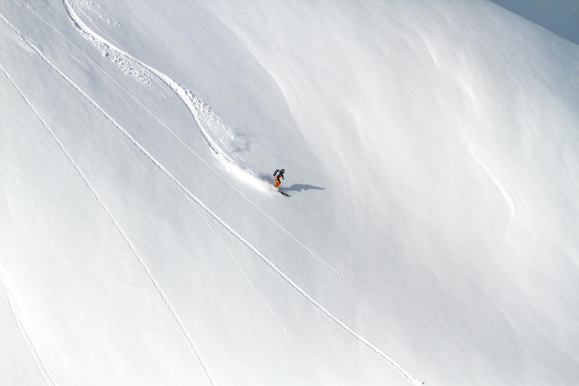 Skier skiing down off-piste mountain