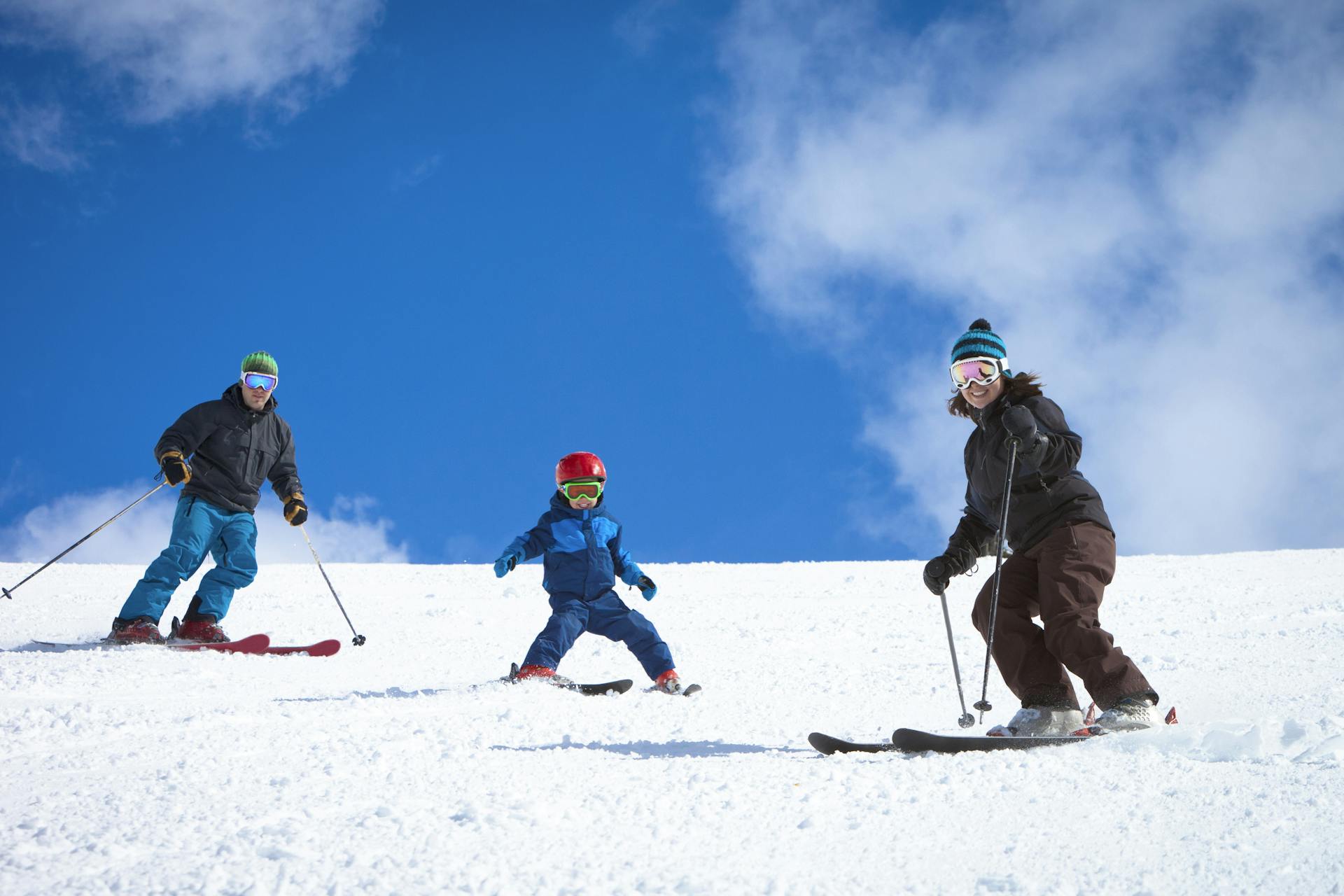 family skiing down ski resort