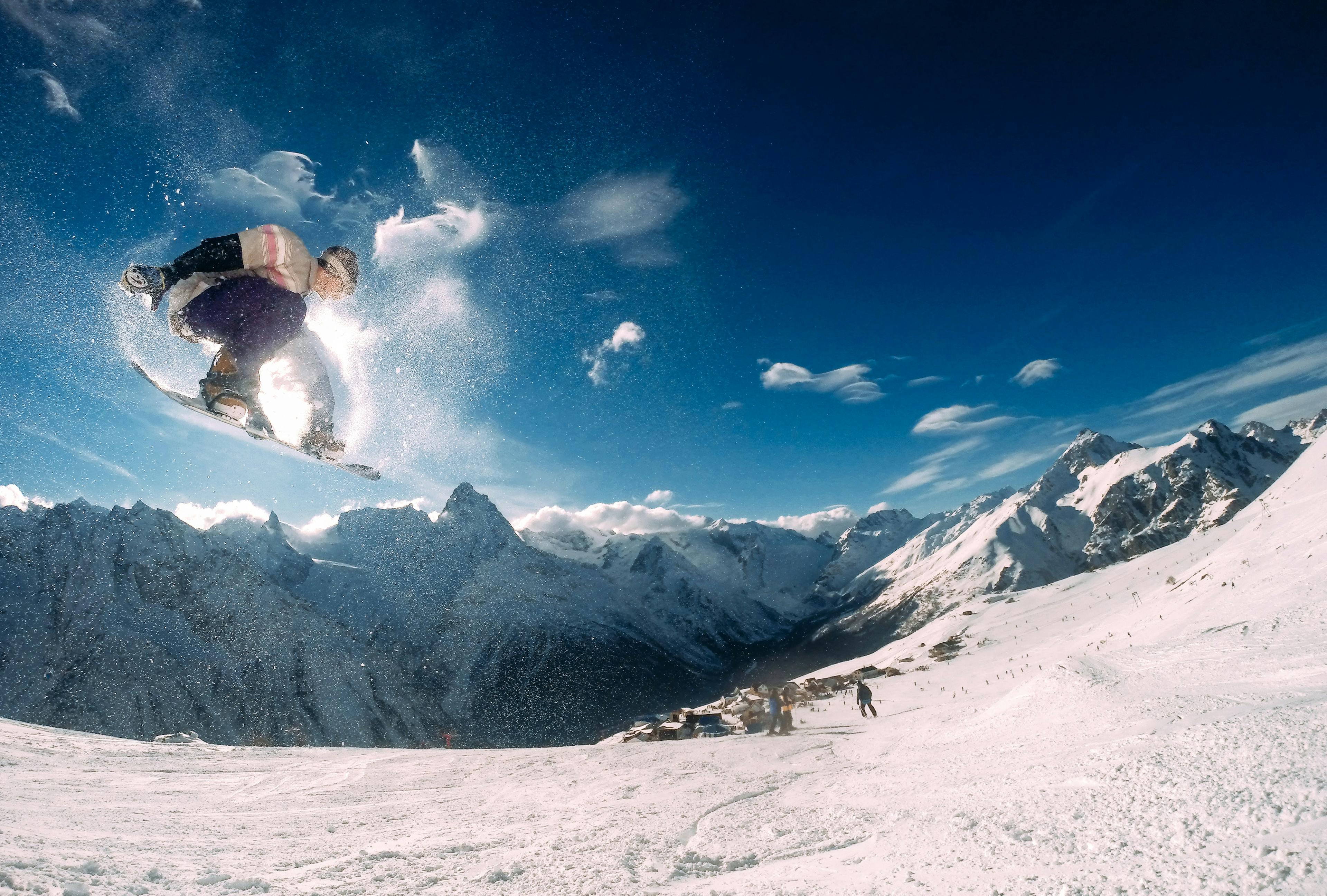 Snowboarder catching air on jump