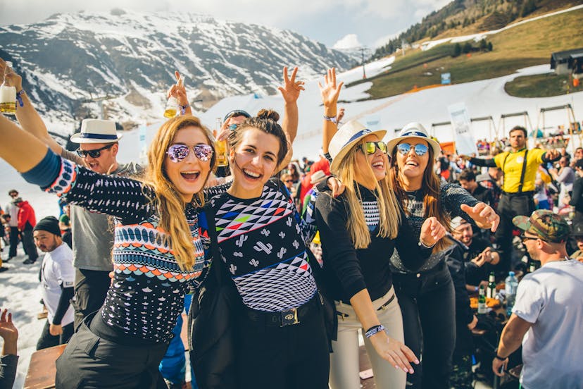 Festival goers enjoying snowbombing festival after day of skiing on slopes