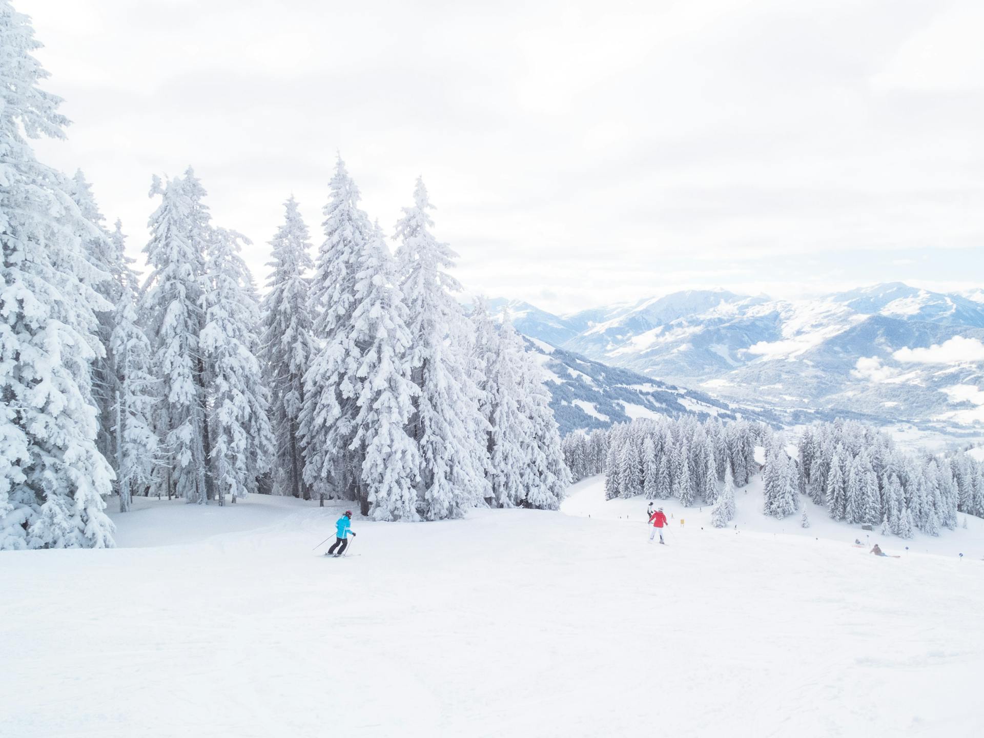 Skiiers skiing down snowy mountain in Austria