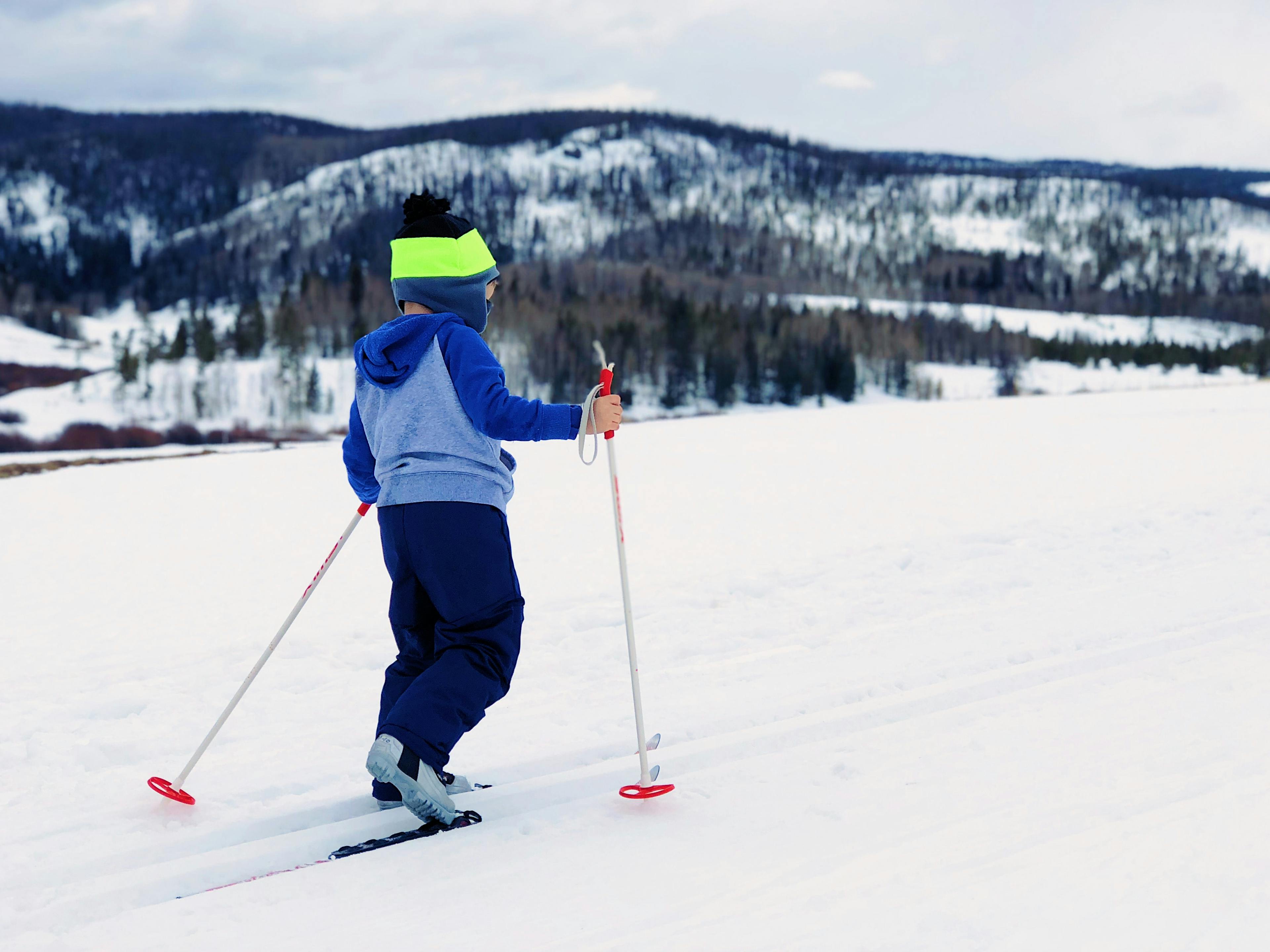 Child cross country skiing on holiday