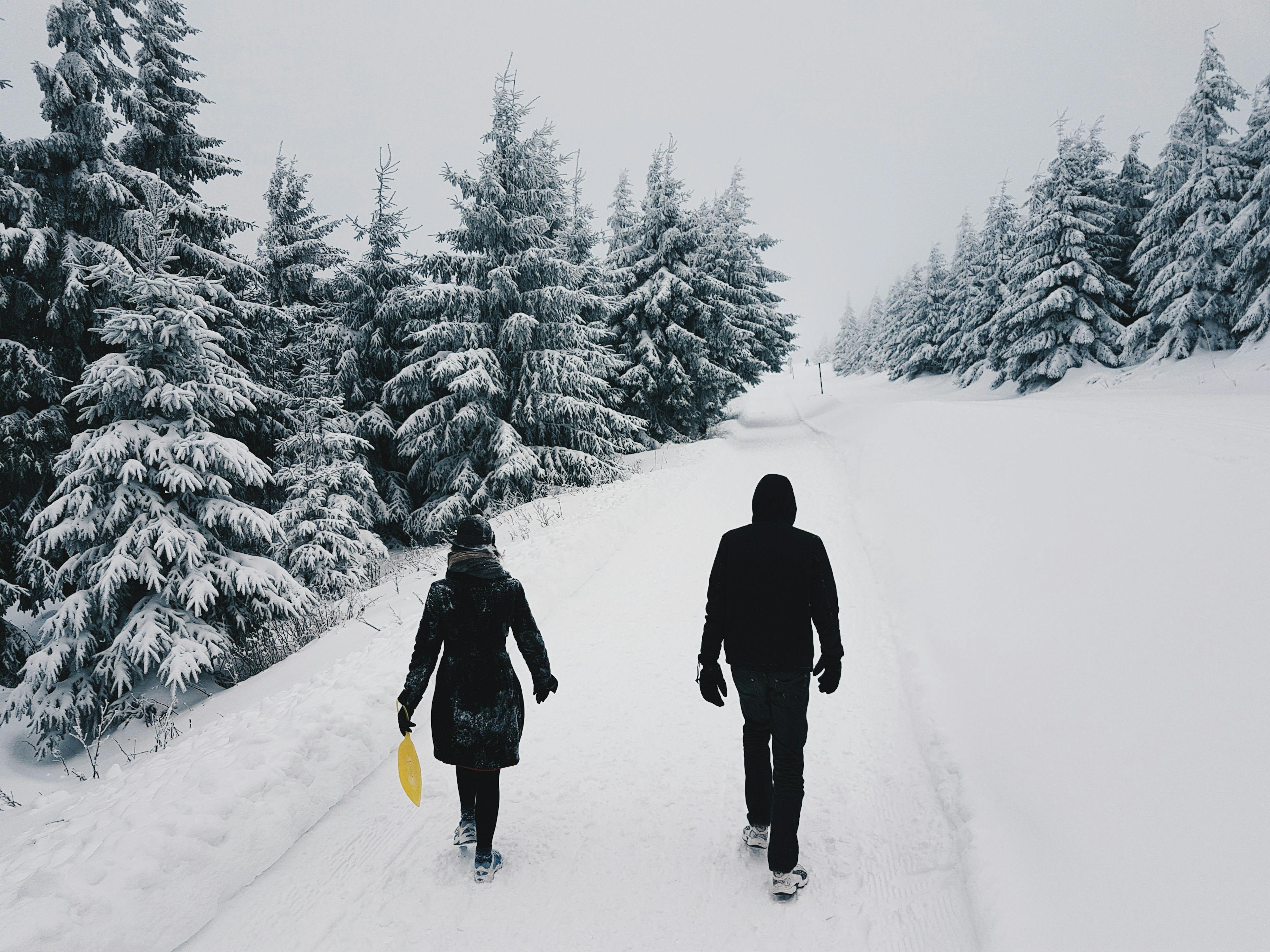 Couple hiking through snow on holiday