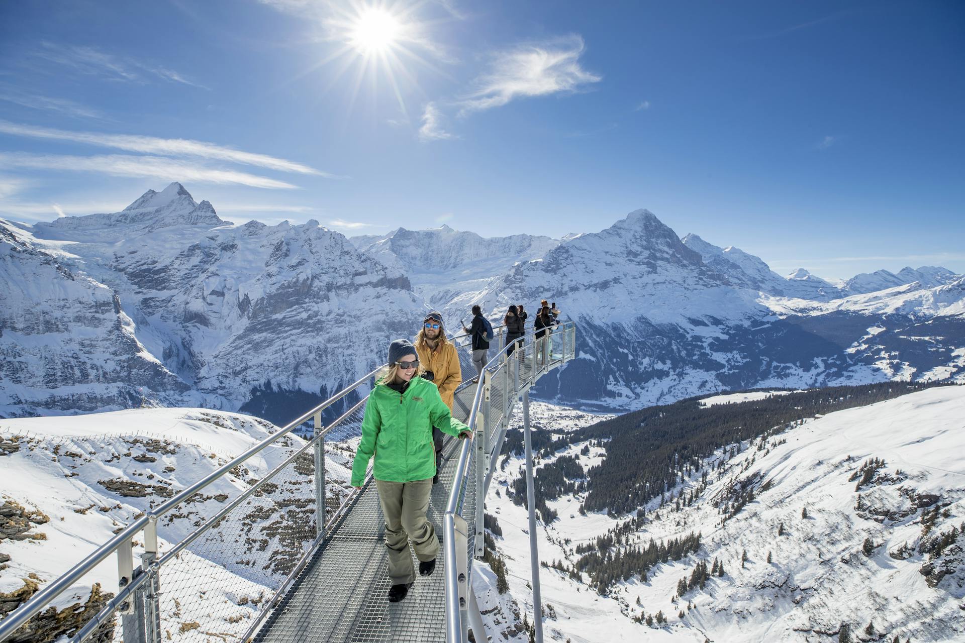 people admiring stunning mountain view from Grindelwald ski resort viewing platform