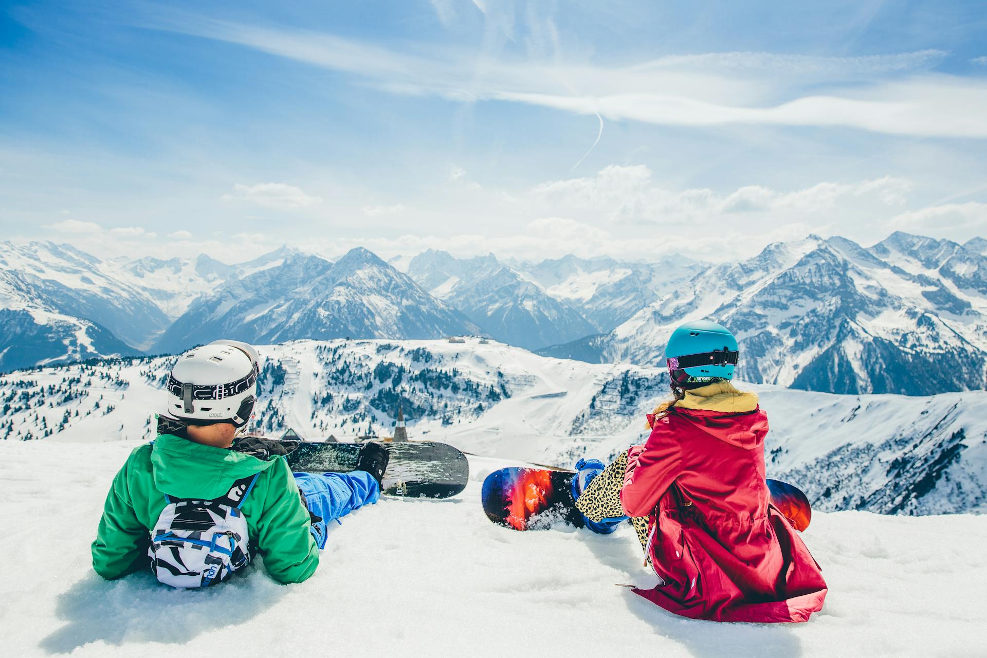 Snowboarders admiring view of Mayrhofen ski resort in winter