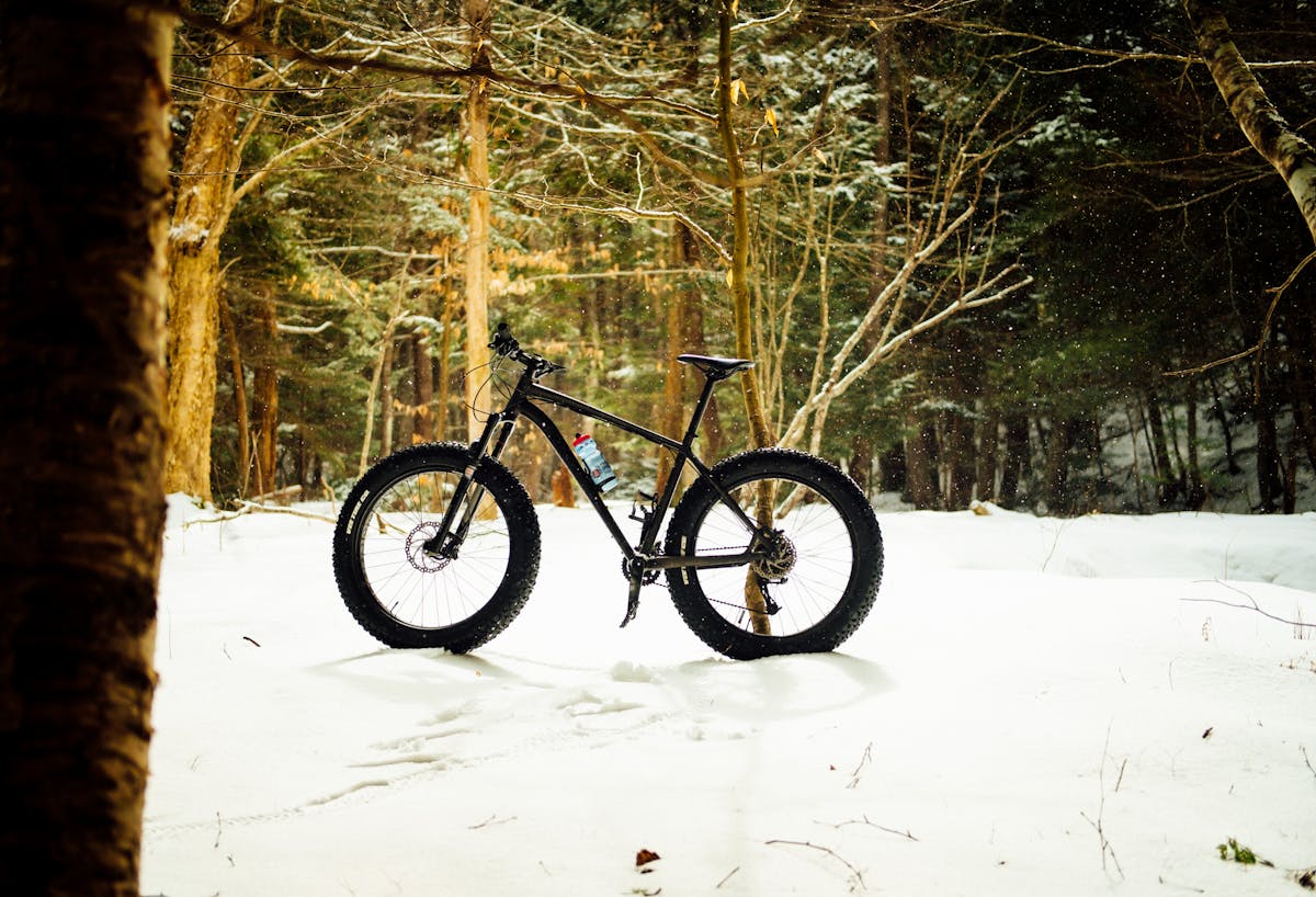Fat bike waiting to be ridden across snowy path