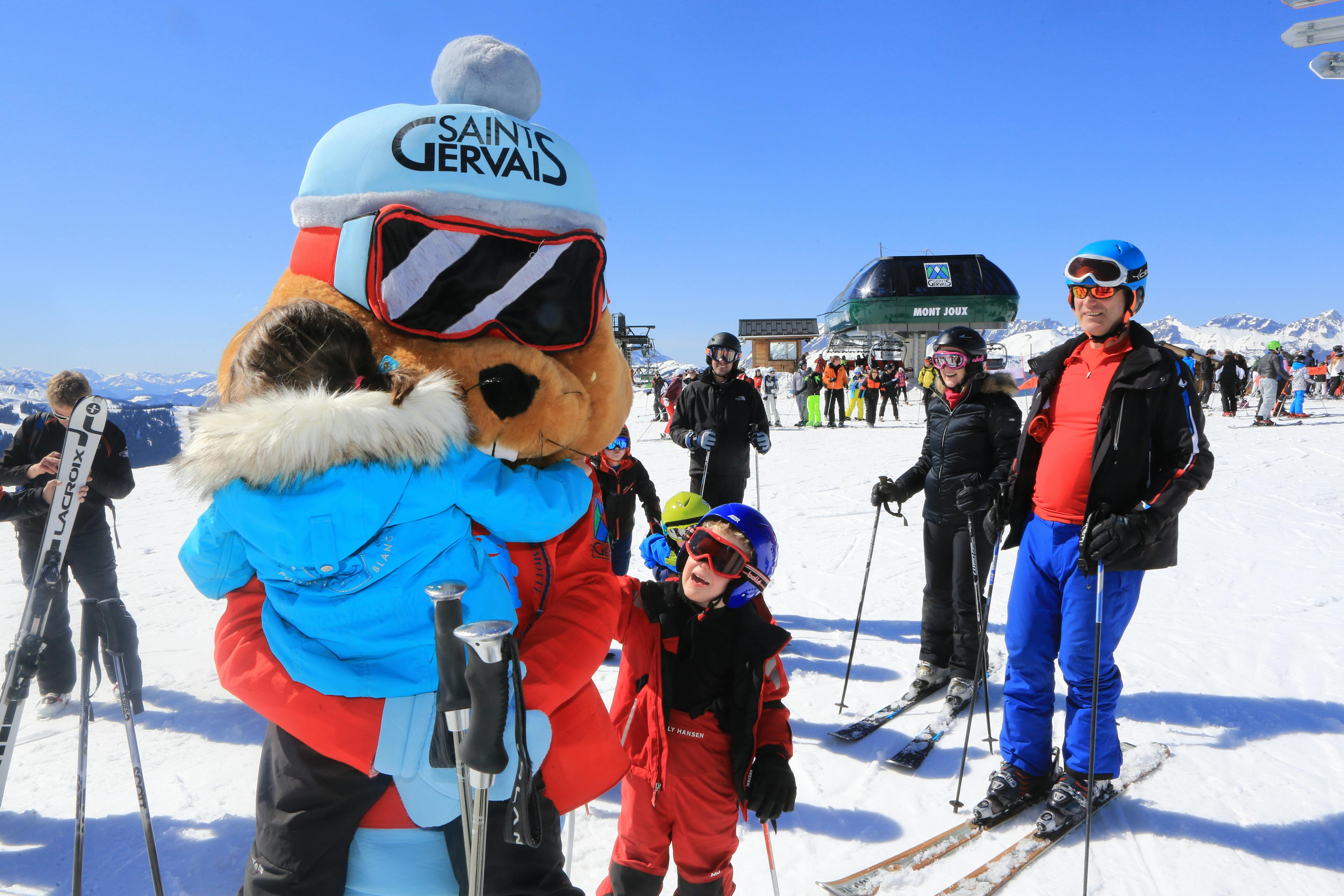 Saint Gervais bear mascot entertaining children skiers on holiday
