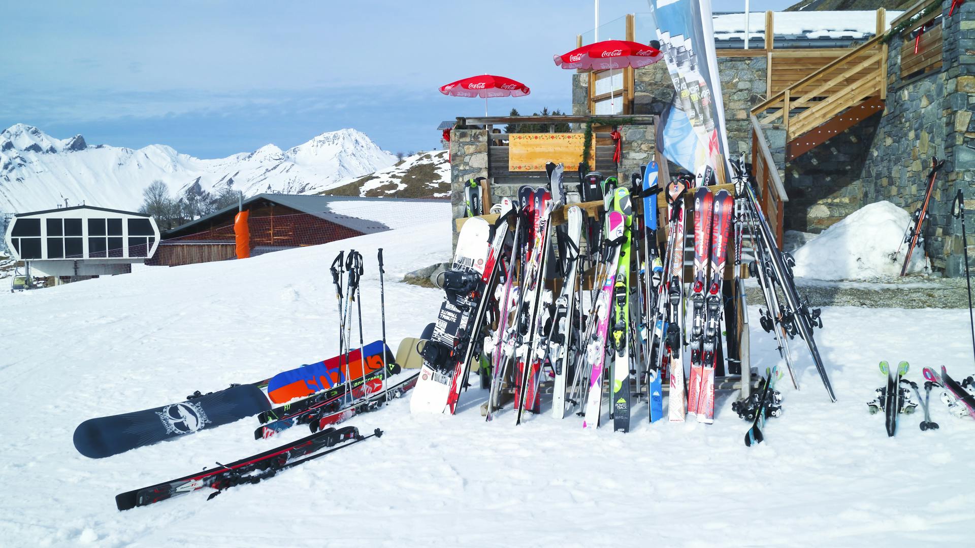 Ski rack overflowing with skis and snowboards