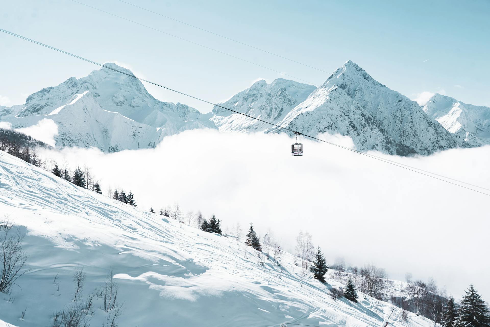 Gondola transporting skiiers to top of Les Deux Alpes ski resort in winter