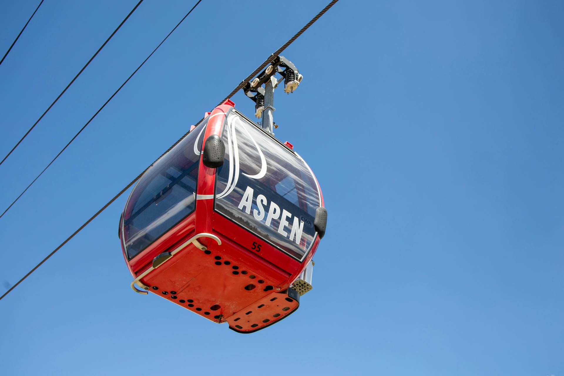 Red cable car with Aspen on written on the front