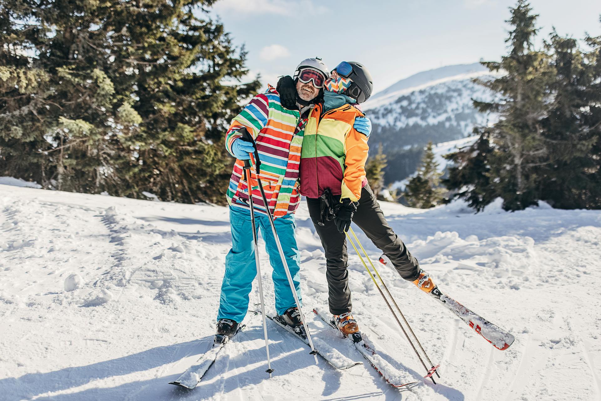 Ski couple hugging on ski slope